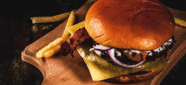 A cheeseburger with bacon and onion, served with fries at The Forum Restaurant Milwaukee Wisconsin.